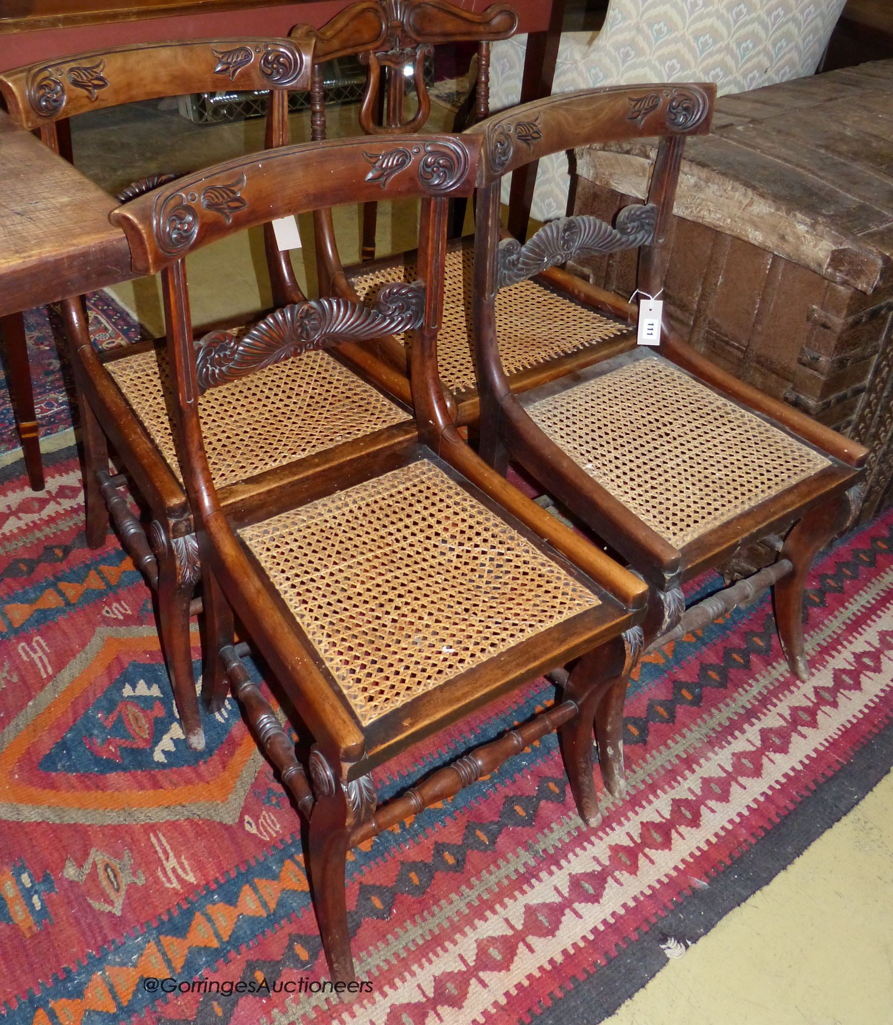 A part set of three Regency stained beech side chairs and another similar chair